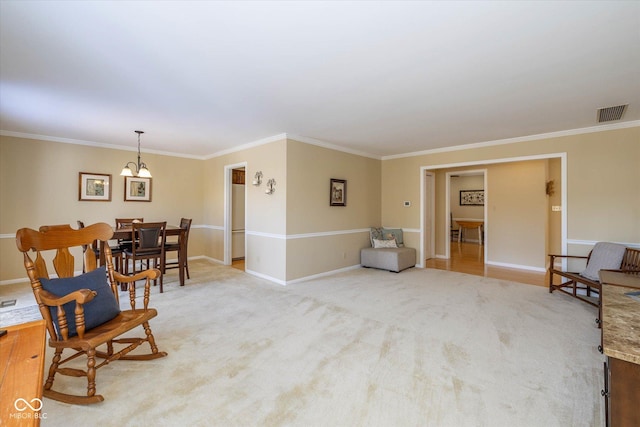 sitting room with light carpet, crown molding, visible vents, and baseboards