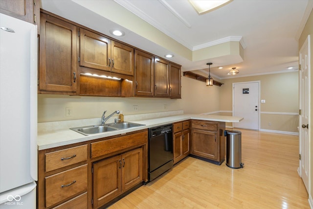 kitchen with a peninsula, light countertops, dishwasher, and freestanding refrigerator