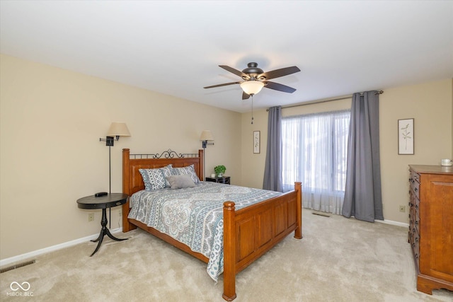 bedroom featuring light carpet, baseboards, visible vents, and ceiling fan