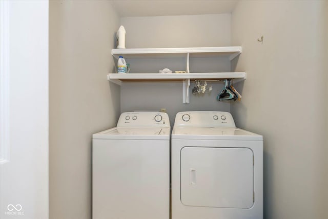 clothes washing area with laundry area and washer and clothes dryer