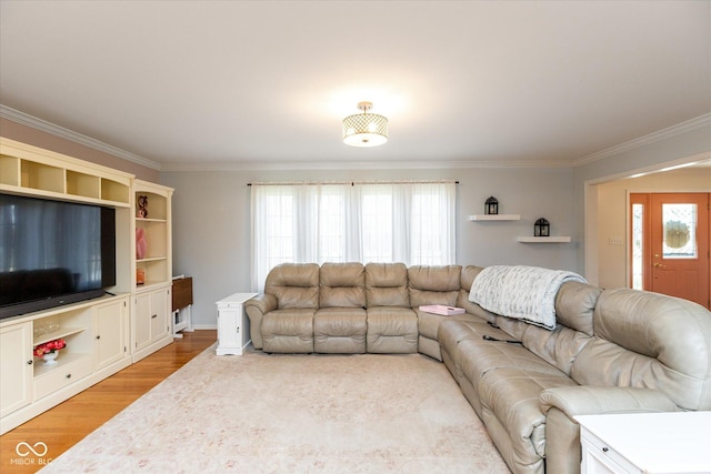 living room featuring crown molding, a wealth of natural light, and light wood-style floors