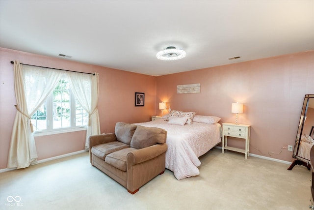 bedroom with visible vents, light carpet, and baseboards