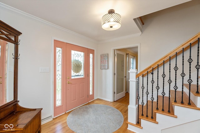 entrance foyer featuring light wood-type flooring, baseboards, stairs, and ornamental molding