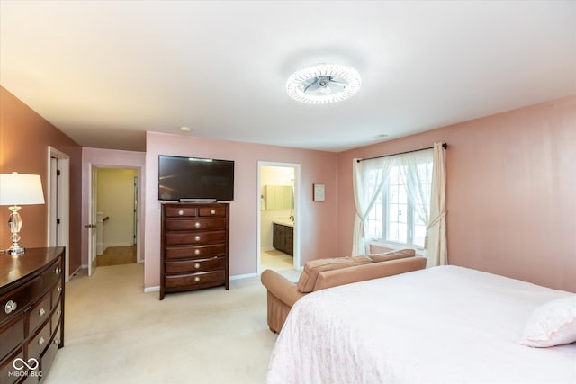 bedroom with light carpet, connected bathroom, and baseboards