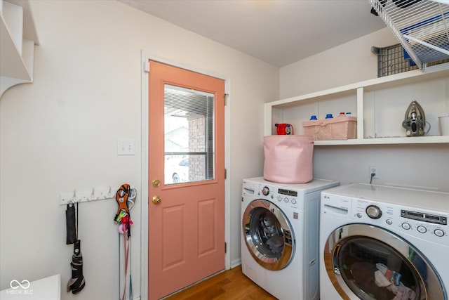 laundry room with light wood-style flooring, laundry area, and washer and clothes dryer