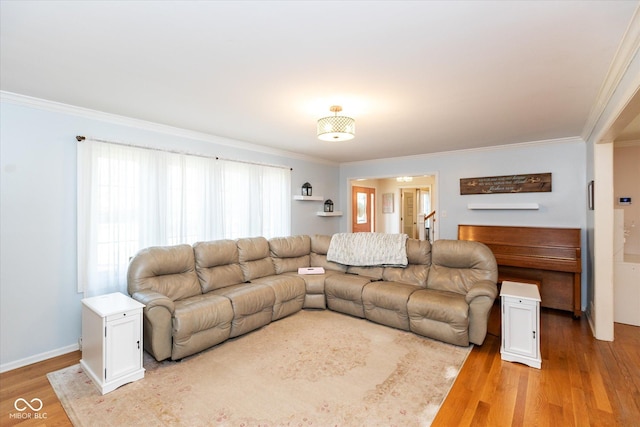 living room with light wood finished floors and ornamental molding