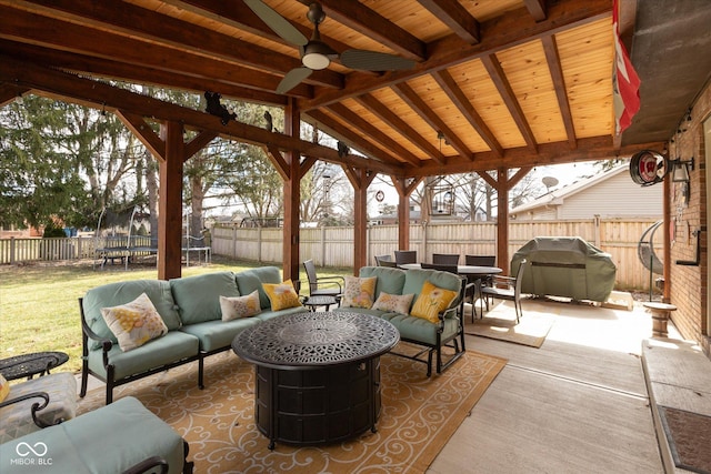 view of patio / terrace with a trampoline, a fenced backyard, an outdoor living space, and area for grilling