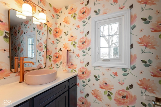 bathroom featuring vanity and wallpapered walls