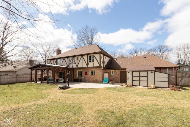 back of property featuring a lawn, a patio, a fenced backyard, a chimney, and a gazebo