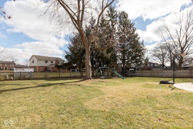 view of yard with a playground and a fenced backyard