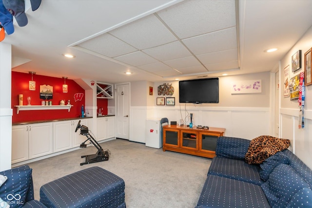 interior space with recessed lighting, light colored carpet, a drop ceiling, and wainscoting