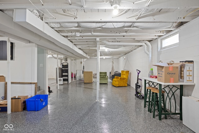 basement with concrete block wall and water heater