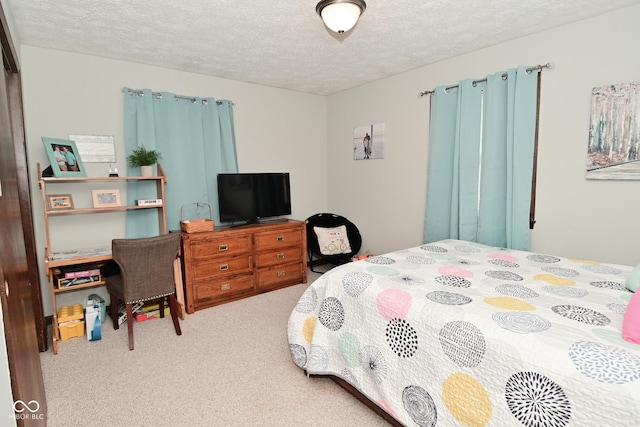 carpeted bedroom featuring a textured ceiling