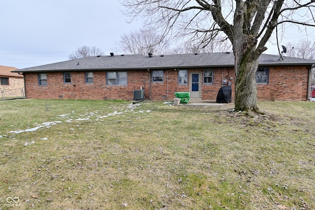 back of house featuring a shingled roof, a lawn, crawl space, cooling unit, and brick siding