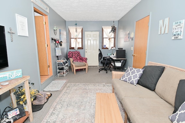 living room featuring light carpet and a textured ceiling