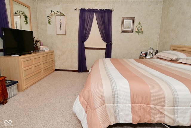 bedroom featuring baseboards and light colored carpet