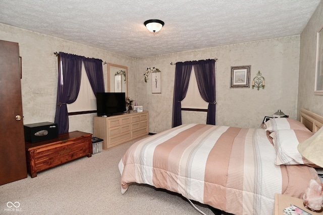 carpeted bedroom with a textured ceiling