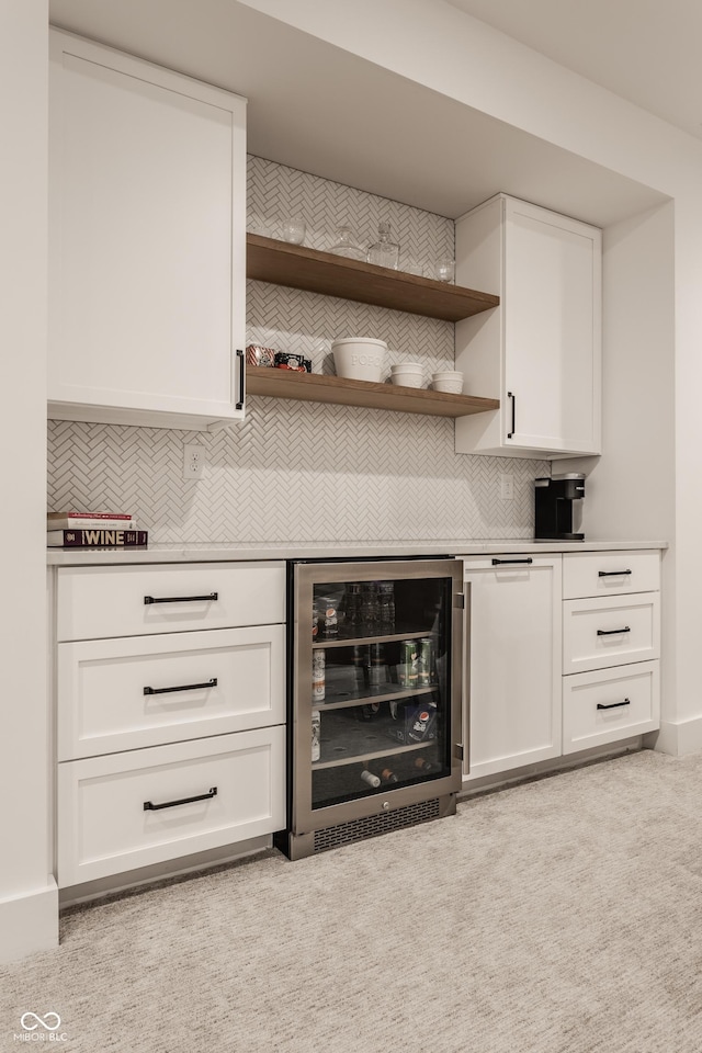 bar featuring beverage cooler and decorative backsplash