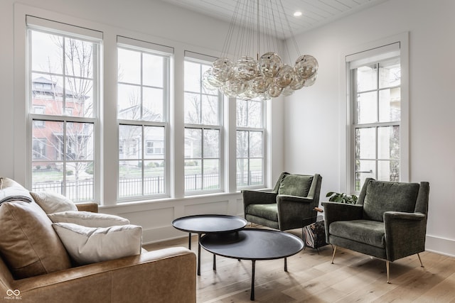 living area featuring light wood-type flooring, a chandelier, and recessed lighting