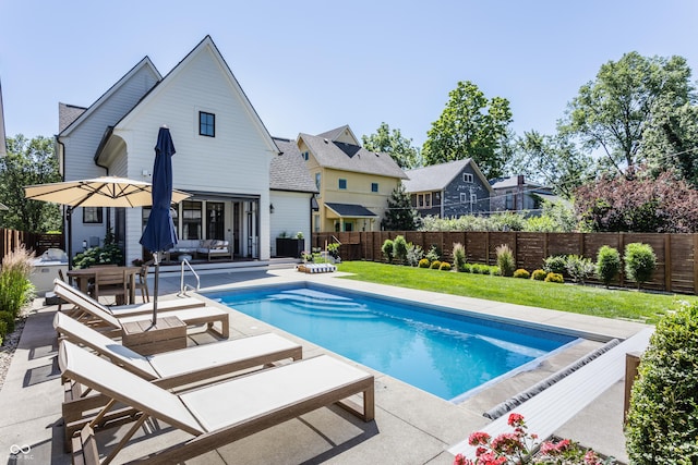 view of pool with a patio area, a fenced backyard, a fenced in pool, and a yard