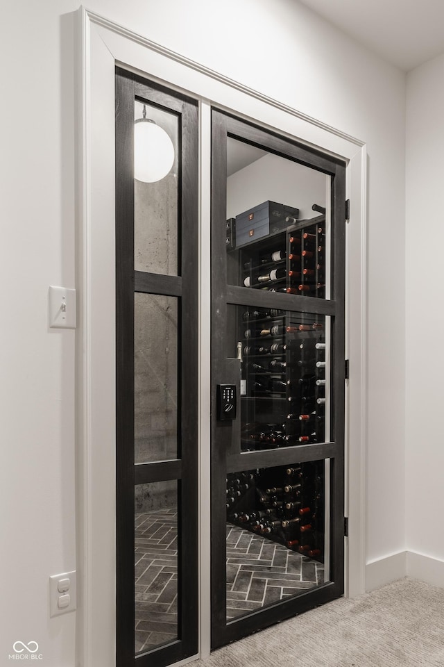 wine cellar with electric panel, baseboards, and carpet flooring