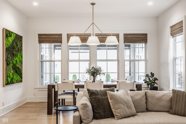 living room with light wood-style floors, baseboards, and recessed lighting