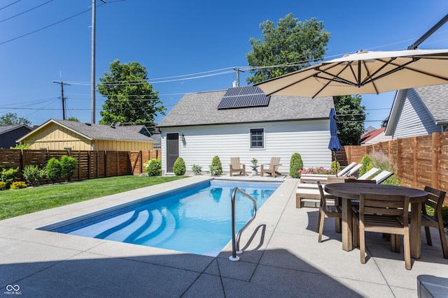 view of swimming pool featuring a lawn, a fenced in pool, a fenced backyard, outdoor dining area, and a patio area