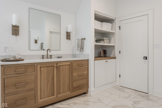 bathroom featuring marble finish floor and vanity