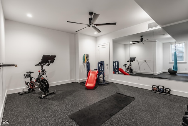 workout area with baseboards, visible vents, and a ceiling fan