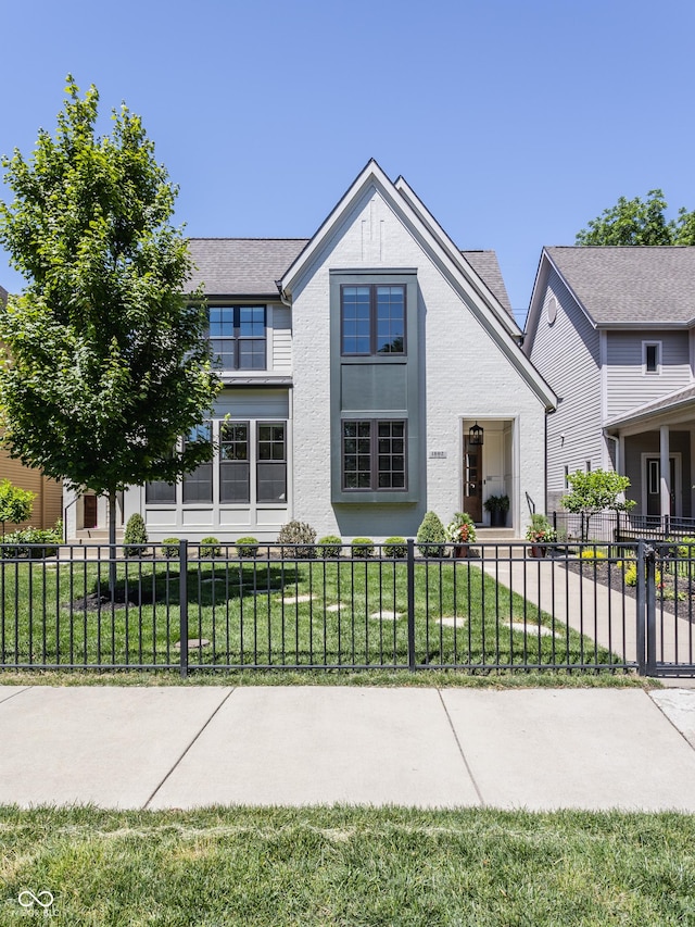 view of front of property with a front lawn, a fenced front yard, and stucco siding