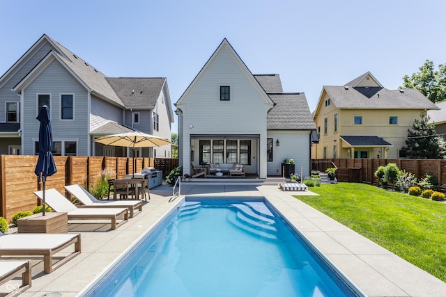 rear view of property with a fenced backyard, an outdoor hangout area, a lawn, and a patio