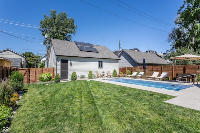 back of house with a fenced in pool, a yard, a patio, solar panels, and a fenced backyard