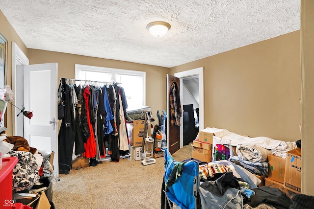 bedroom featuring carpet floors and a textured ceiling