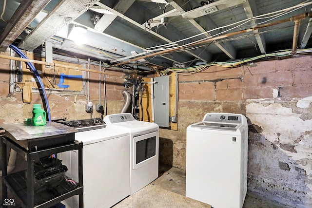 clothes washing area with laundry area, washer and clothes dryer, and electric panel