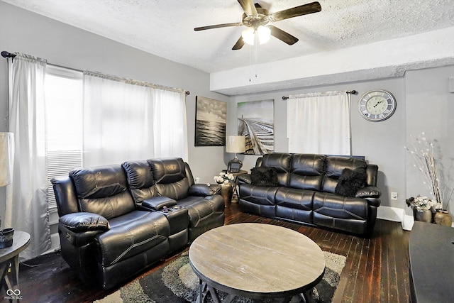 living room featuring wood-type flooring, ceiling fan, and a textured ceiling