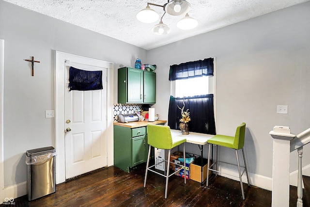 office featuring a textured ceiling, dark wood-style flooring, and baseboards