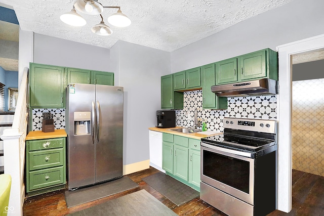 2401 N Olney St, Indianapolis, IN 46218 - kitchen featuring under cabinet range hood, stainless steel appliances, green cabinetry, dark wood-style floors, and a textured ceiling