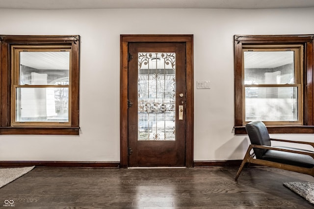 entryway with dark wood-type flooring and baseboards