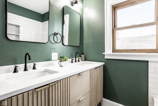 bathroom with double vanity and a sink