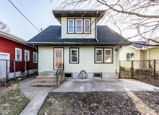 back of house with a patio area, a gate, fence, and a shingled roof