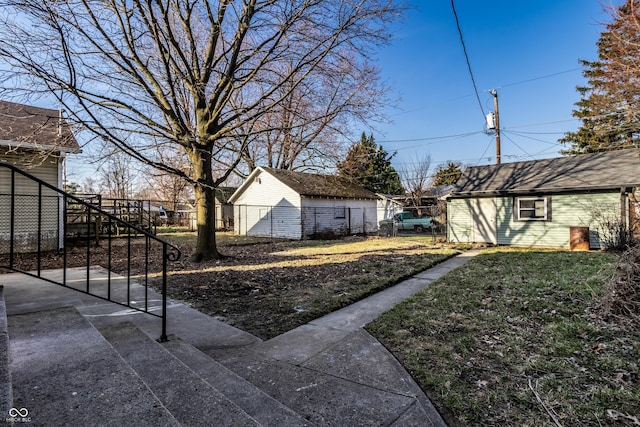 view of yard with an outdoor structure and fence