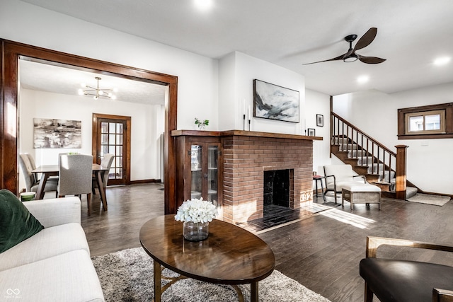 living room featuring a brick fireplace, baseboards, recessed lighting, wood finished floors, and a ceiling fan