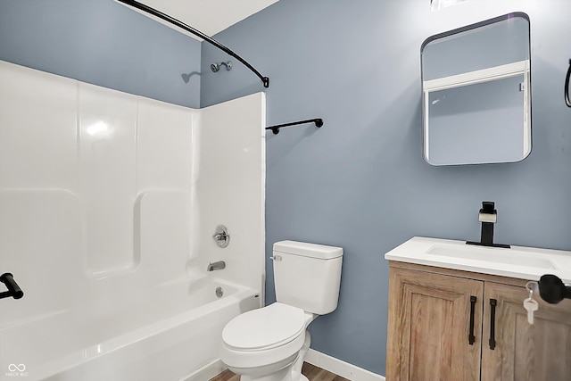 full bath featuring  shower combination, vanity, toilet, and baseboards