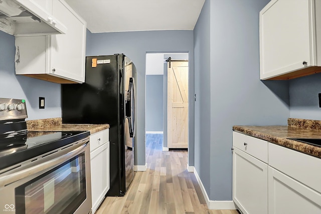 kitchen featuring a barn door, light wood-style flooring, under cabinet range hood, white cabinetry, and stainless steel electric range