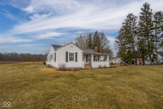 view of front of property with a chimney and a front yard