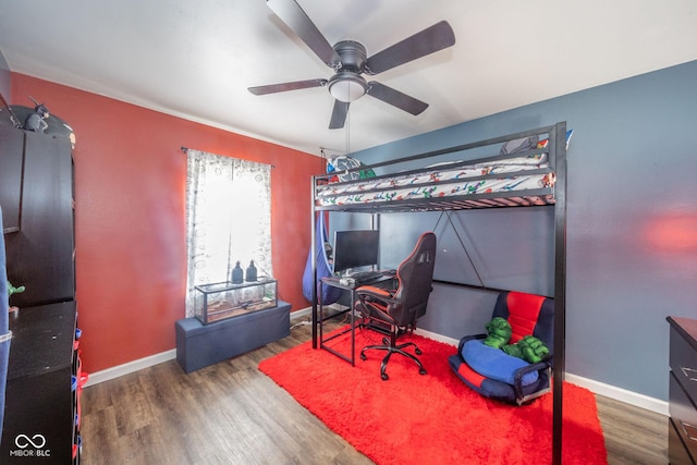 bedroom featuring ceiling fan, wood finished floors, and baseboards