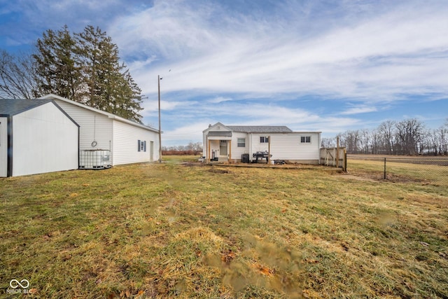 view of yard featuring fence and an outdoor structure