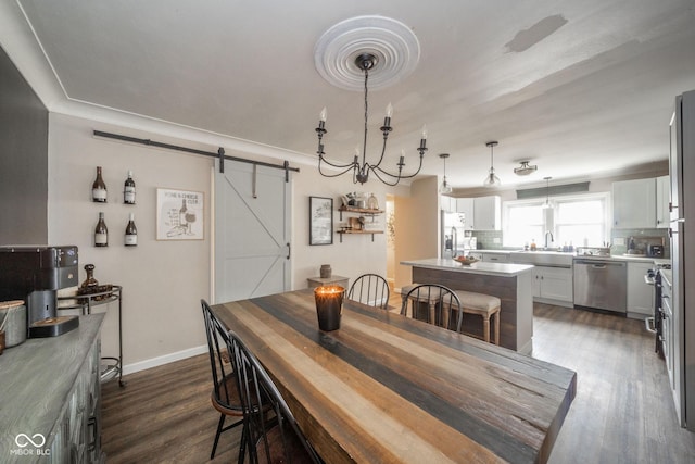 dining space with dark wood finished floors, baseboards, and a barn door