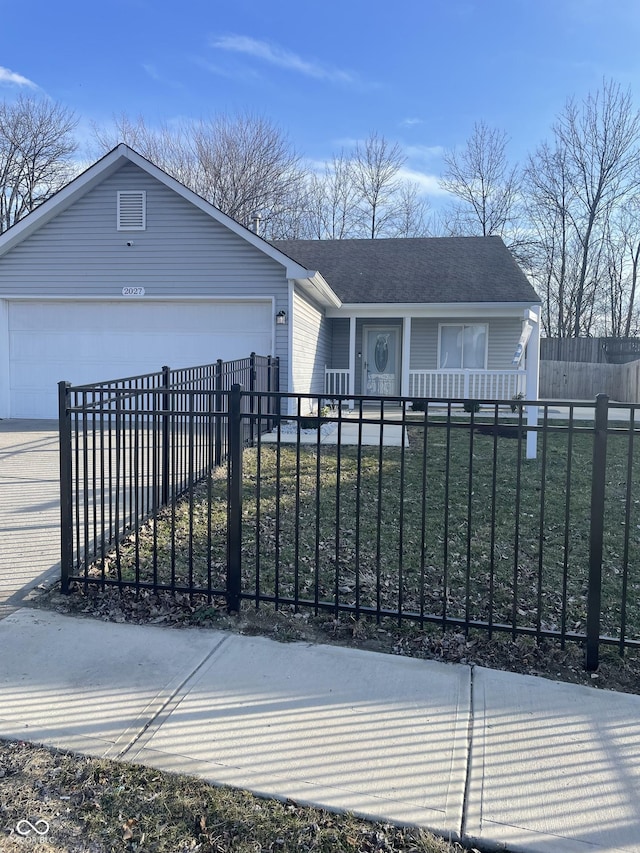 view of front facade with a porch, a fenced front yard, a garage, driveway, and a front lawn