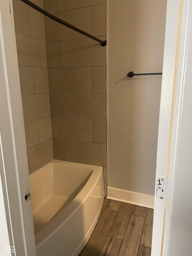 full bathroom with baseboards and wood finished floors